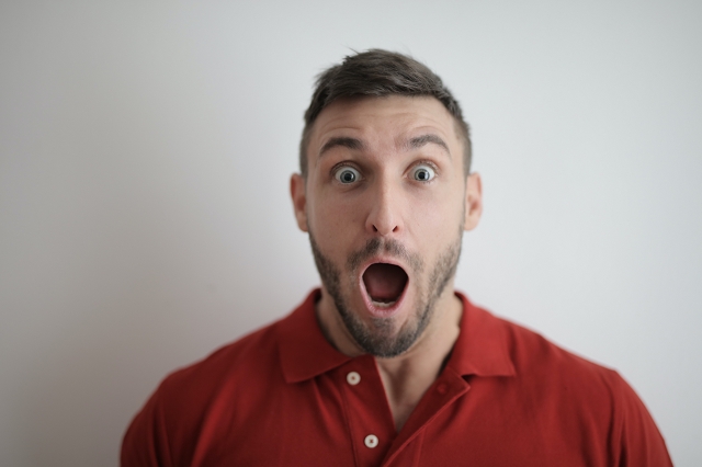 Man expressing surprise showcasing potential before and after results of hair transplant surgery, a popular medical tourism procedure in Turkey