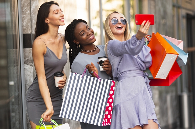 Database marketing - A group of shoppers celebrating their purchases, illustrating the importance of trade and e-commerce in today’s digital age.