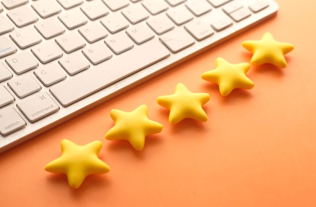 Customer review concept. Rating golden stars on orange background