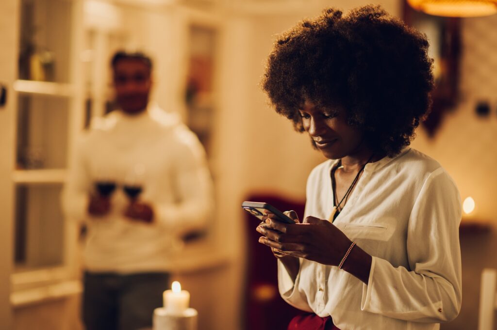 Portrait of a beautiful african american woman using a smartphone at home